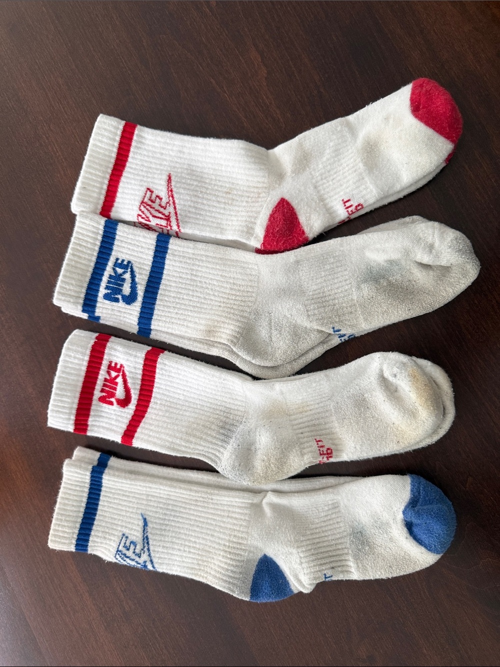 4 pairs Nike White Crew Athletic Socks with Red and Blue Accents heel to toe 8”.